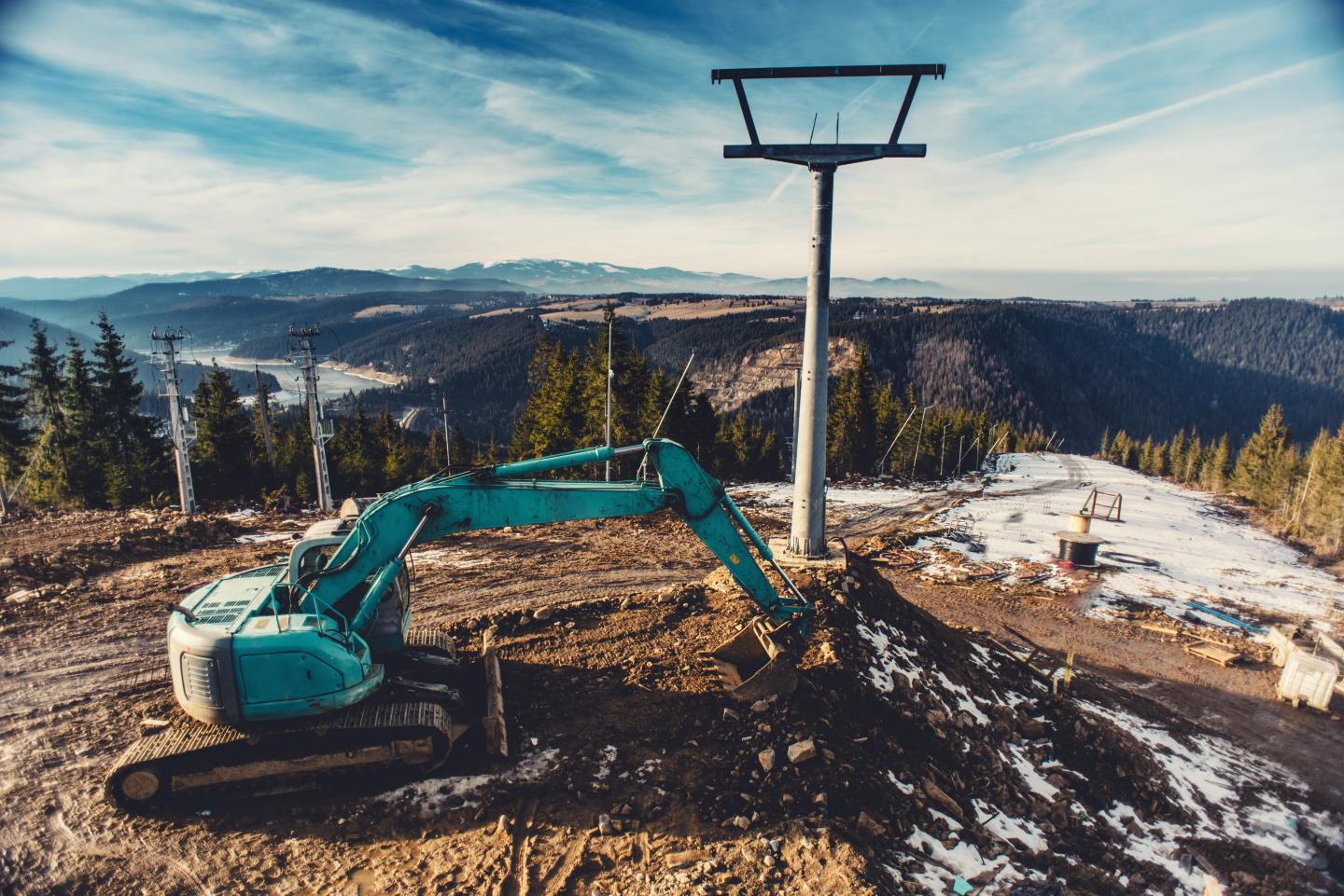 An excavator building a chairlift