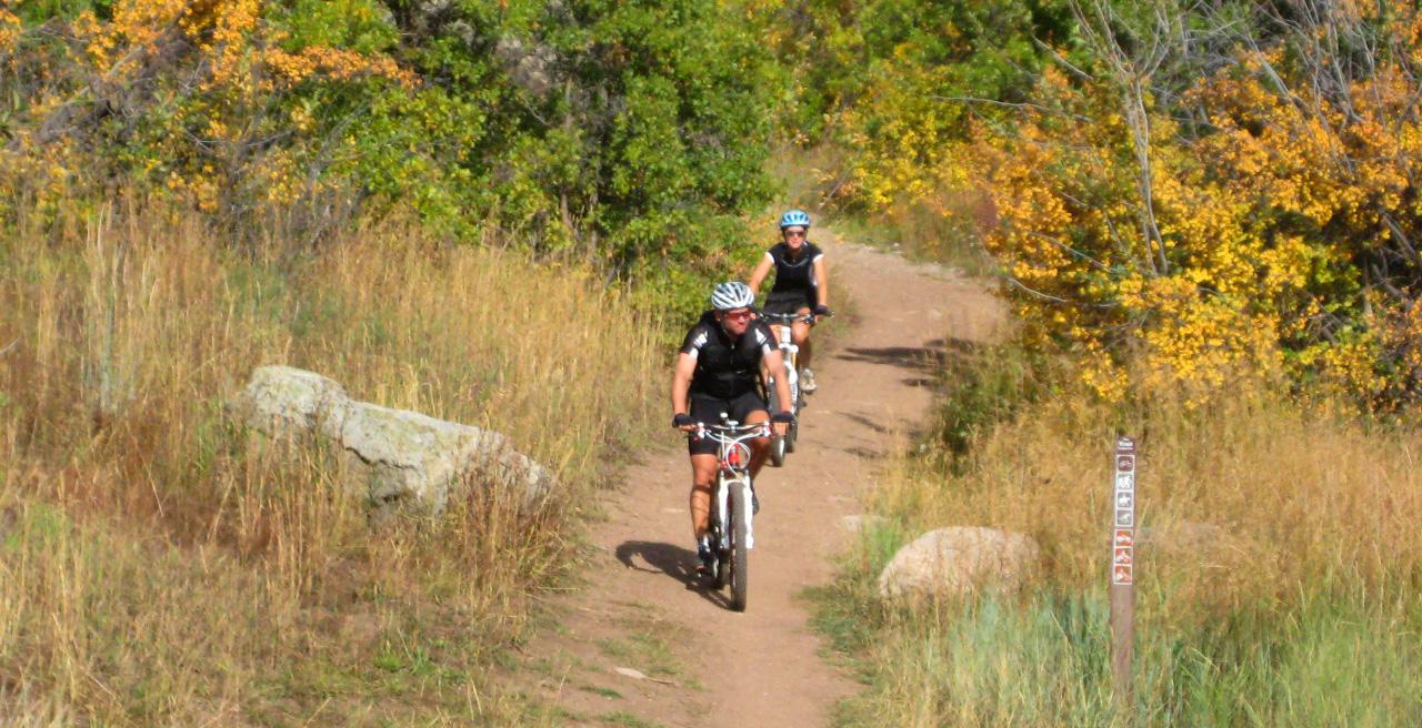 Two people biking on a trail