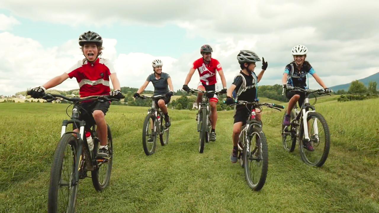 A family riding their bikes through a park