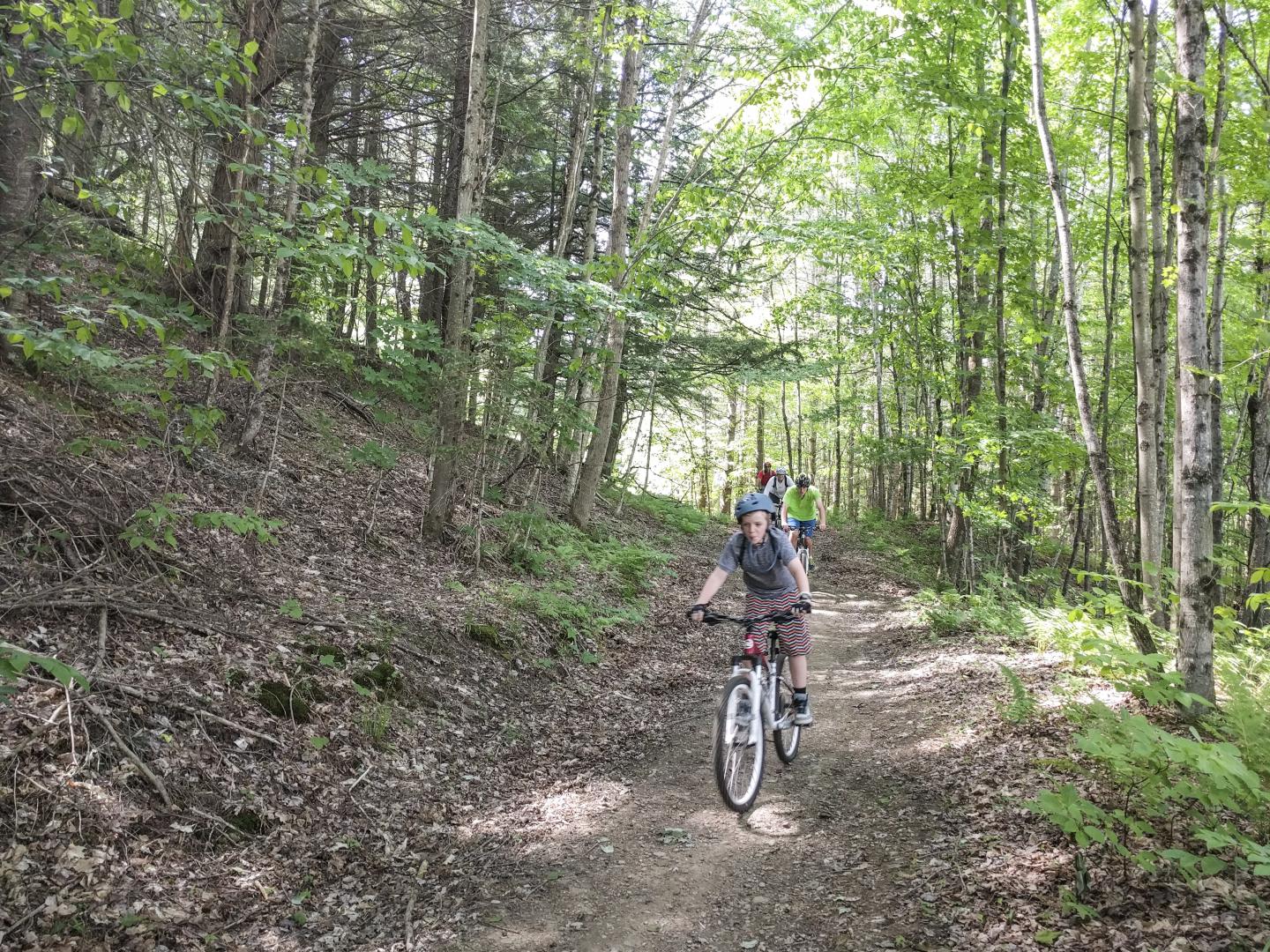 A family biking down a trail