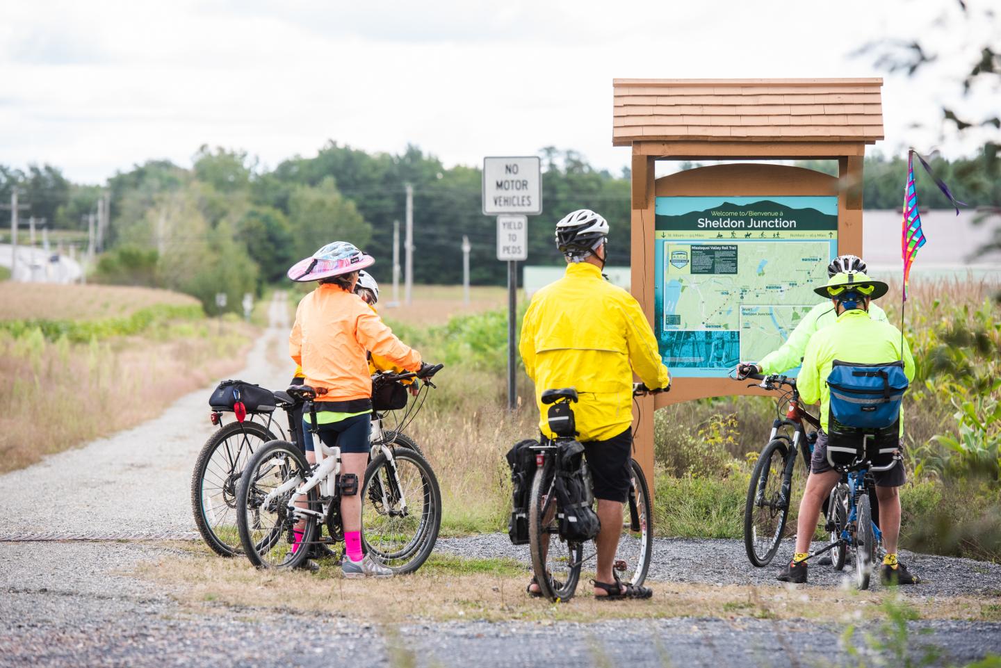 Bikers viewing a trail way finding sign