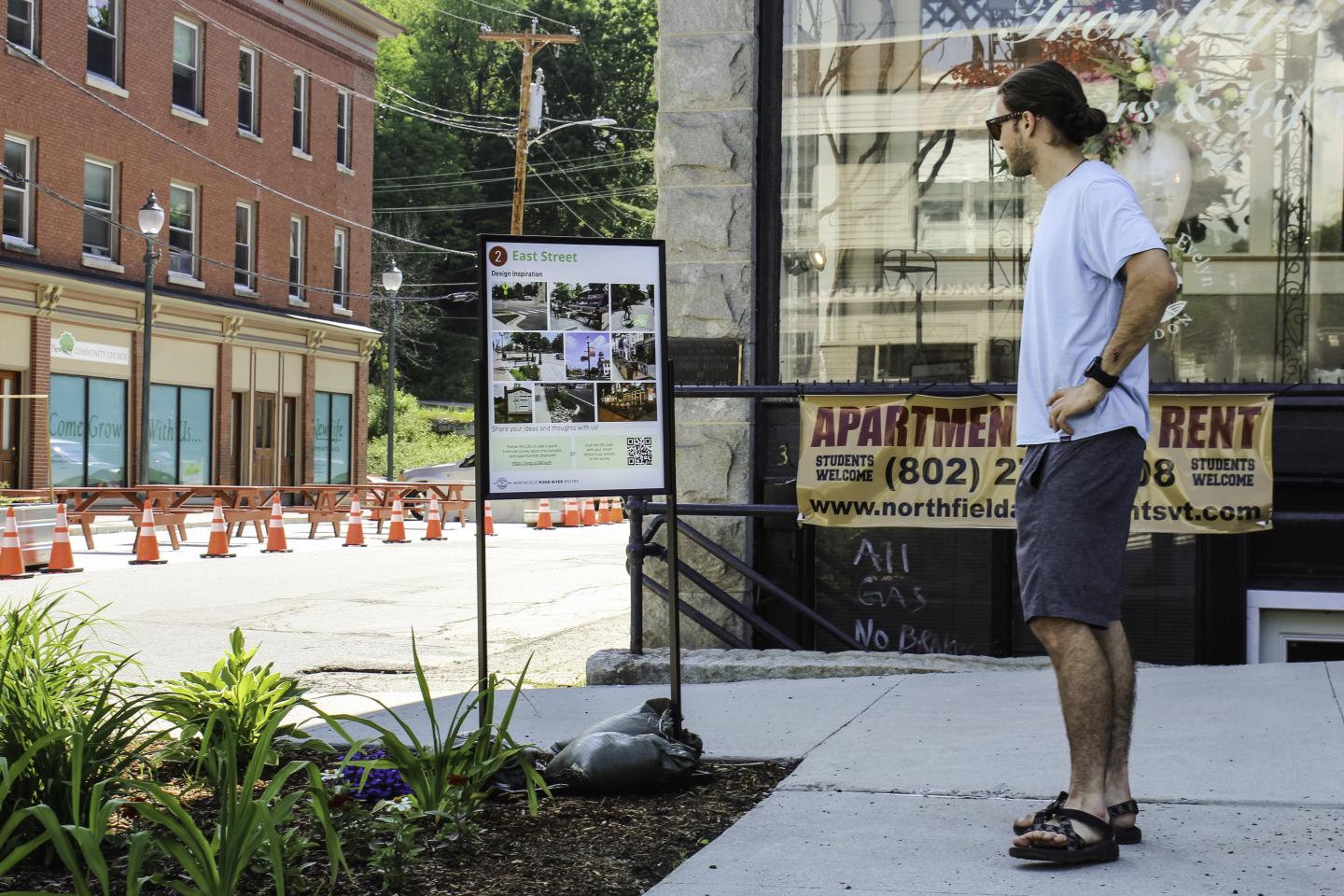 A man looking at a sign