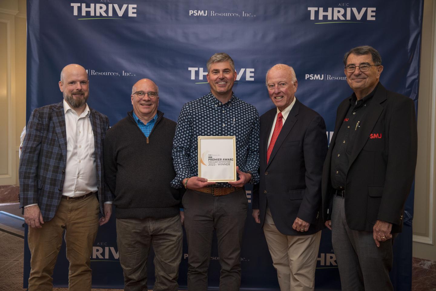 The SE Group team holding an award