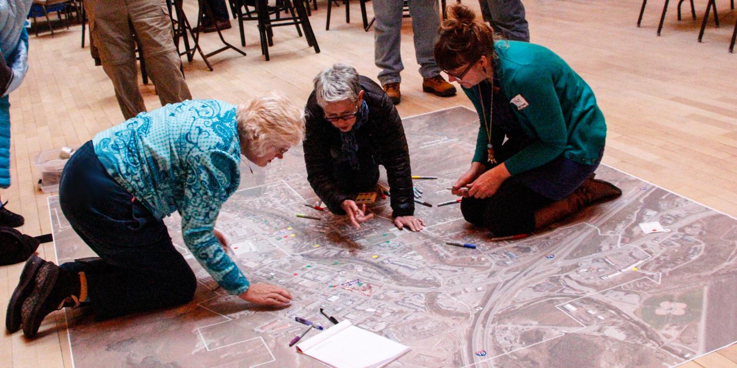 Three people working on a town plan