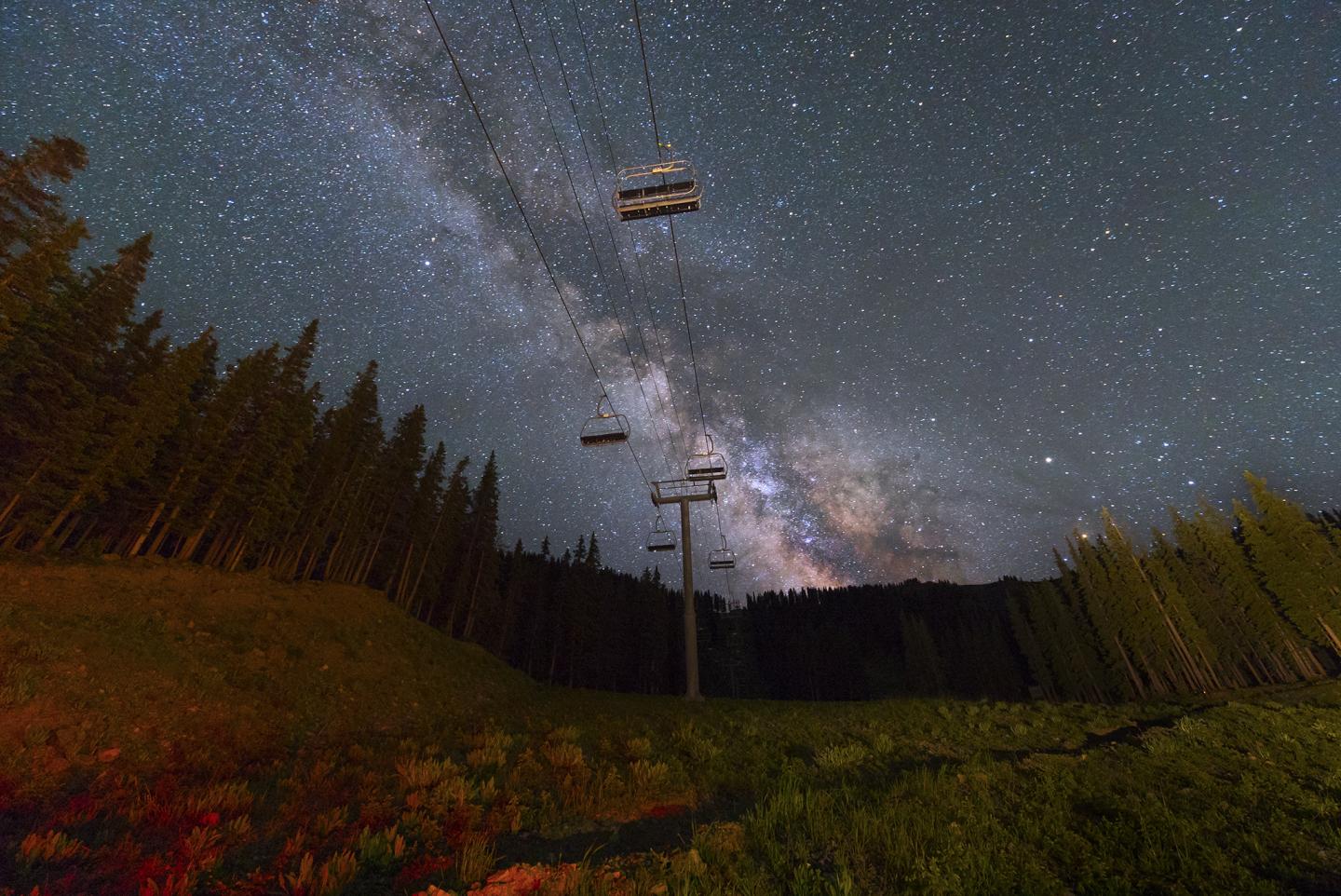 View of a chairlift at night with the milky way in the sky