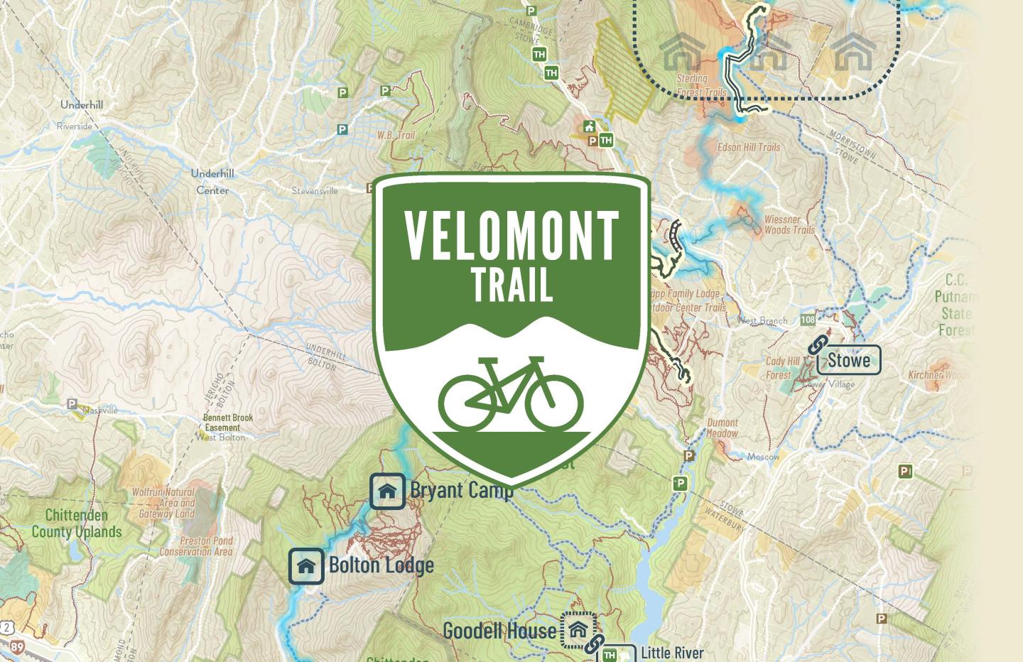 The Velomont logo over a map of Vermont