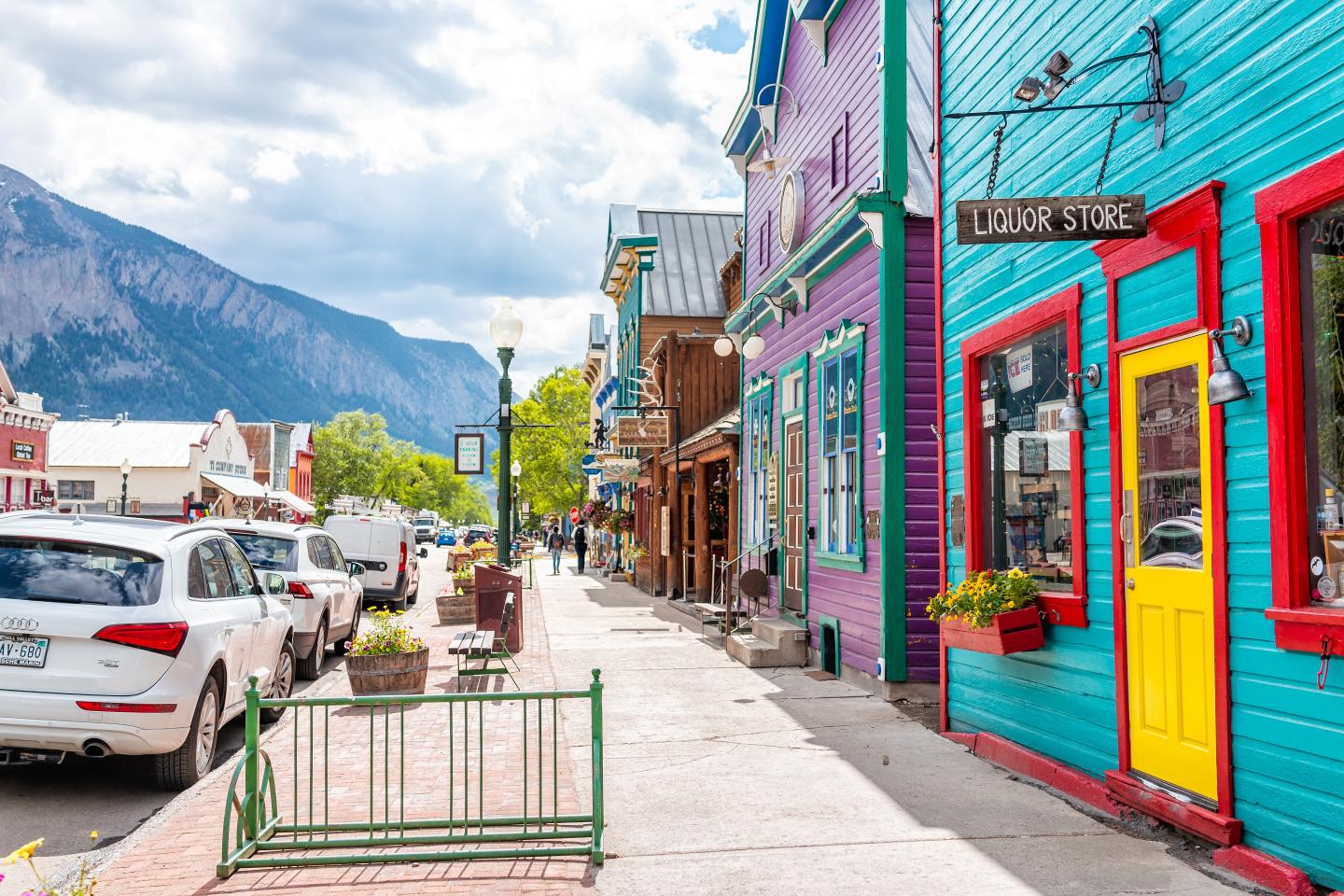 Colorful street with vibrant facades, mountains in the background of downtown Crested Butte